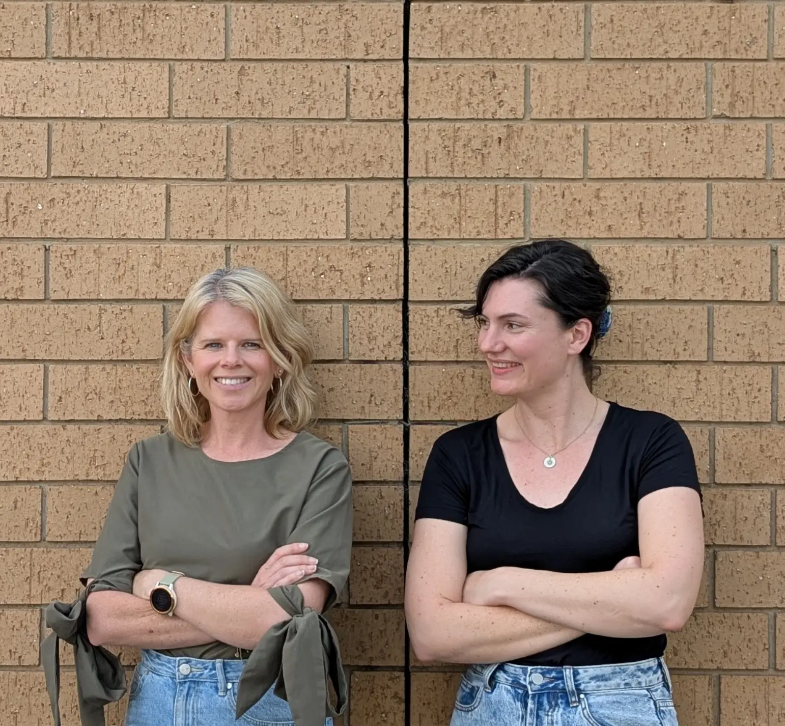 Unleased co-founders Clair Crowley and Jacqui Storey standing in front of a brick wall